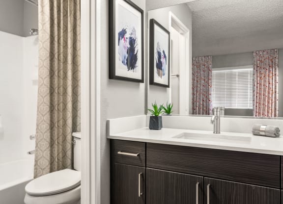 a bathroom with a toilet sink and bathtub in a 555 waverly unit
